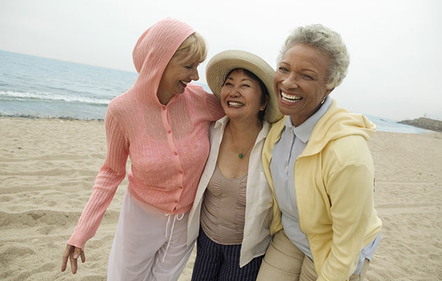 women laughing on beach
